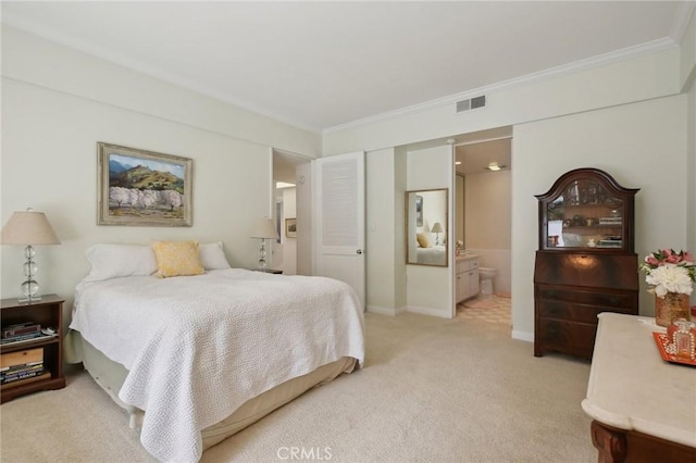 bedroom featuring light carpet, crown molding, ensuite bath, and baseboards