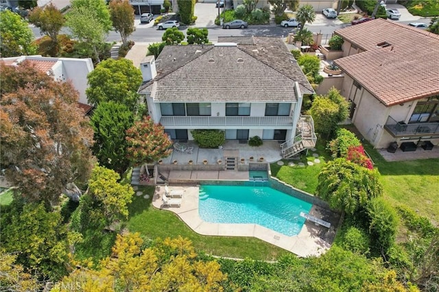 aerial view of property and surrounding area featuring a pool
