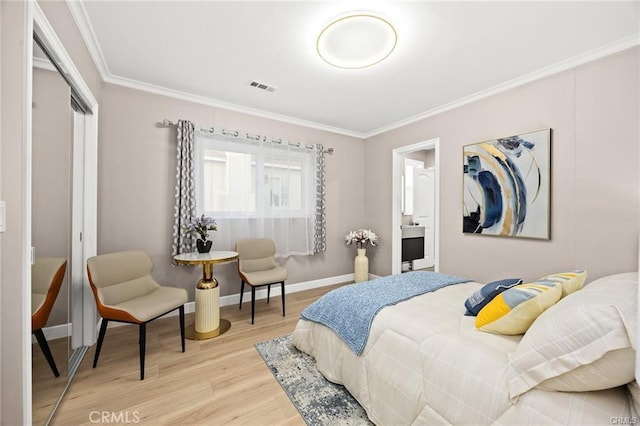 bedroom featuring a closet, light wood-style floors, baseboards, ornamental molding, and visible vents