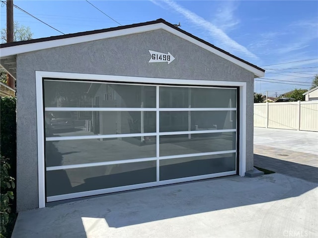 detached garage featuring fence