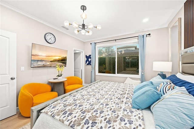 bedroom with a notable chandelier, wood finished floors, crown molding, and visible vents