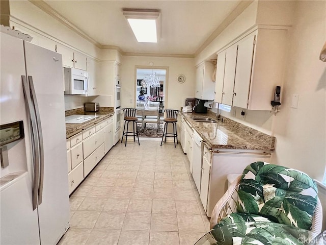 2117 Glenn St, Los Osos, CA 93402 - kitchen featuring a sink, ornamental molding, white appliances, and white cabinets