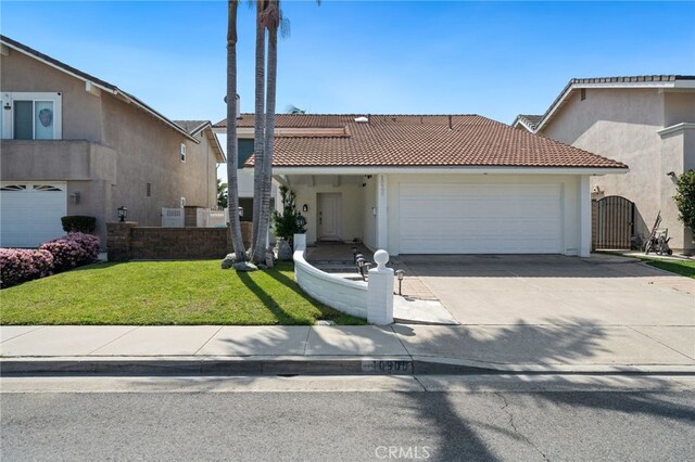 10900 San Leon Ave, Fountain Valley, CA 92708 - view of front of house with a garage, a tiled roof, a front lawn, and driveway