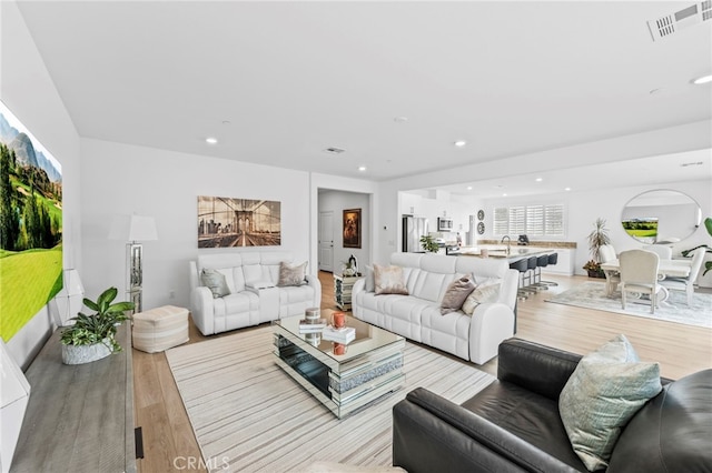 5053 Moon Eye Way, Hemet, CA 92545 - living room with visible vents, recessed lighting, and light wood-type flooring
