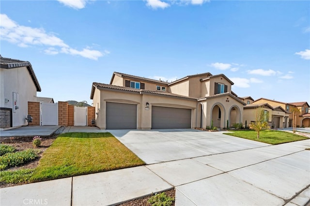 5053 Moon Eye Way, Hemet, CA 92545 - mediterranean / spanish-style house featuring a gate, driveway, an attached garage, a tile roof, and stucco siding
