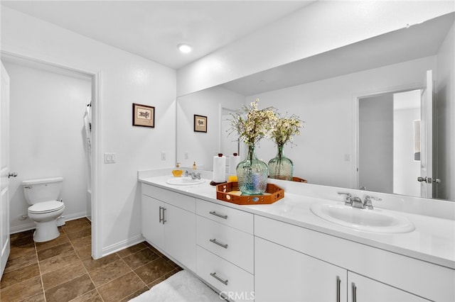 5053 Moon Eye Way, Hemet, CA 92545 - full bathroom featuring toilet, a sink, double vanity, and baseboards