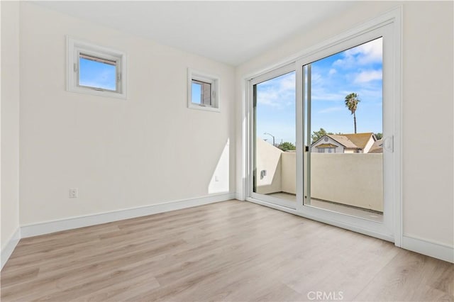 empty room featuring baseboards and wood finished floors