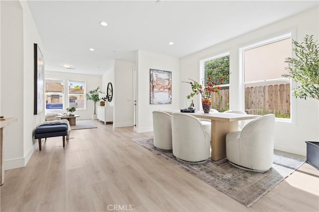 sitting room with baseboards, light wood finished floors, and recessed lighting