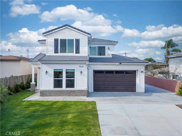 view of front of property with a tile roof, fence, stone siding, driveway, and a front yard