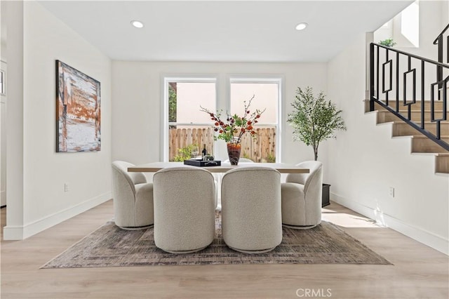 dining area featuring stairs, wood finished floors, baseboards, and recessed lighting