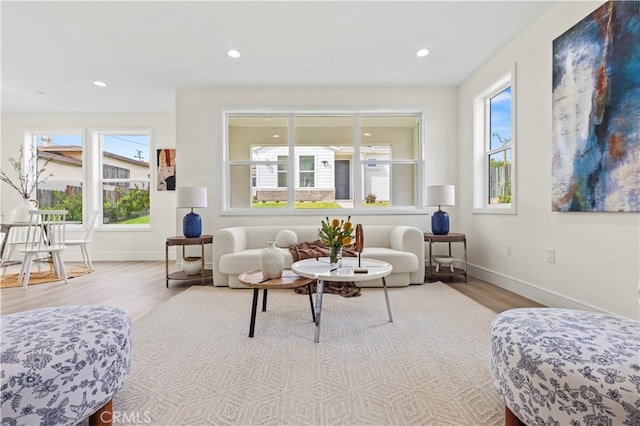 living area featuring recessed lighting, baseboards, and wood finished floors