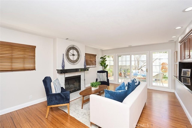 385 Park Ave, Long Beach, CA 90814 - living room with baseboards, recessed lighting, light wood-style flooring, and a glass covered fireplace