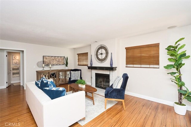 385 Park Ave, Long Beach, CA 90814 - living area with baseboards, a glass covered fireplace, and hardwood / wood-style flooring