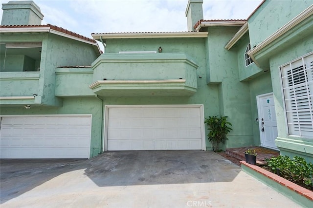 385 Park Ave, Long Beach, CA 90814 - view of front of property featuring stucco siding, driveway, a chimney, and a garage