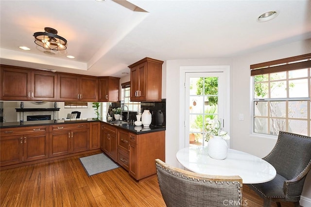 385 Park Ave, Long Beach, CA 90814 - kitchen featuring dark countertops, a healthy amount of sunlight, a sink, and light wood-style floors