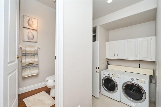 385 Park Ave, Long Beach, CA 90814 - washroom with baseboards, cabinet space, and washing machine and clothes dryer