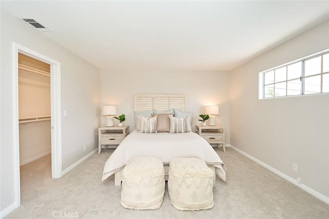 385 Park Ave, Long Beach, CA 90814 - bedroom with baseboards, visible vents, light carpet, and a walk in closet