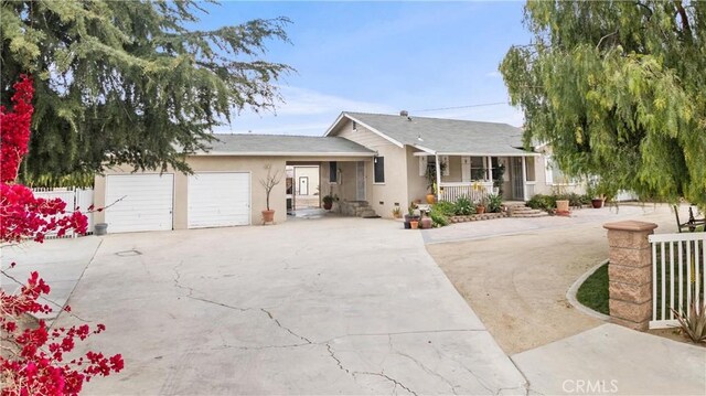 681 E Washington Ave, San Jacinto, CA 92583 - ranch-style house featuring concrete driveway, a porch, stucco siding, and an attached garage
