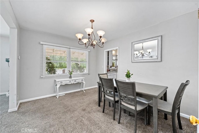 681 E Washington Ave, San Jacinto, CA 92583 - dining area featuring a chandelier, light colored carpet, and baseboards