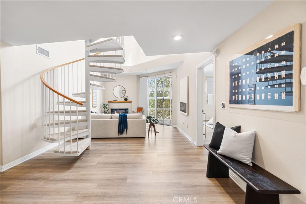 foyer with visible vents, baseboards, wood finished floors, recessed lighting, and stairway