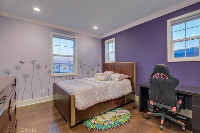 bedroom featuring multiple windows, wood finished floors, baseboards, and ornamental molding