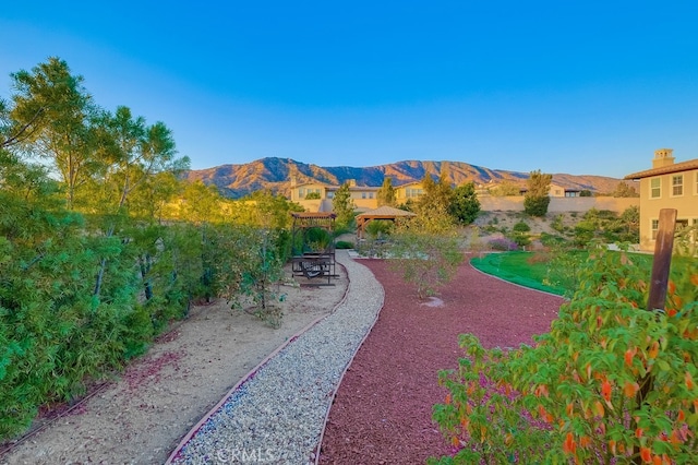 view of community featuring a gazebo, a patio area, and a mountain view