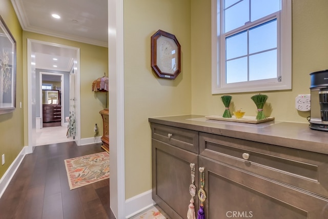 interior space featuring baseboards, wood finished floors, recessed lighting, and crown molding