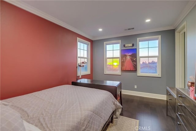 bedroom featuring visible vents, baseboards, ornamental molding, and dark wood finished floors