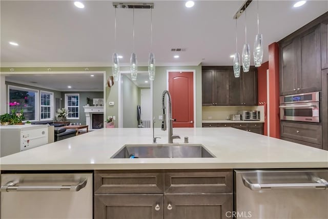 kitchen with light countertops, visible vents, appliances with stainless steel finishes, and a sink