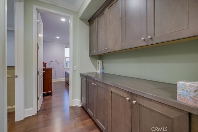 interior space featuring recessed lighting, baseboards, dark wood-style floors, and ornamental molding