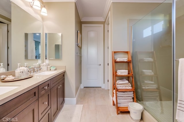 bathroom with a shower stall, double vanity, wood finished floors, a sink, and crown molding