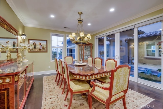 dining area with dark wood-style floors, an inviting chandelier, visible vents, ornamental molding, and baseboards