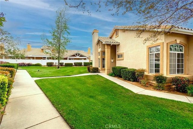 exterior space with fence and a yard