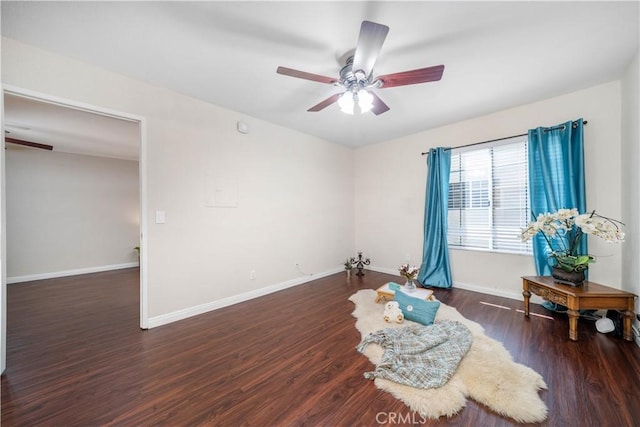 sitting room featuring baseboards, ceiling fan, and wood finished floors