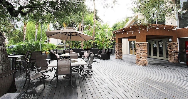 wooden deck with outdoor lounge area and outdoor dining space