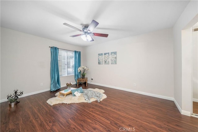unfurnished room featuring a ceiling fan, visible vents, baseboards, and wood finished floors
