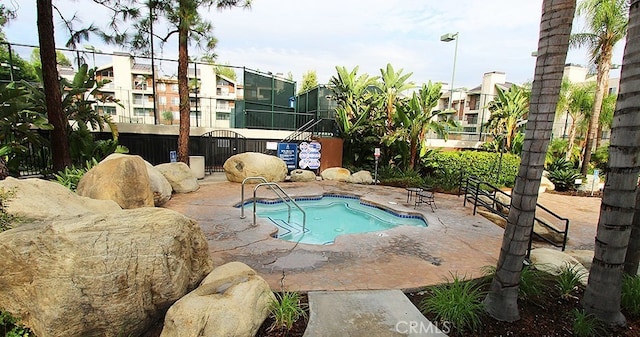 view of pool with a patio area, fence, and a pool