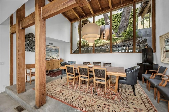 1503 Skylark Ln, Los Angeles, CA 90069 - dining area featuring concrete flooring, lofted ceiling with beams, and visible vents