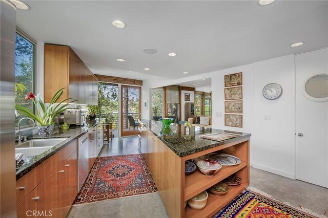 1503 Skylark Ln, Los Angeles, CA 90069 - kitchen featuring stainless steel dishwasher, dark stone counters, a sink, and open shelves