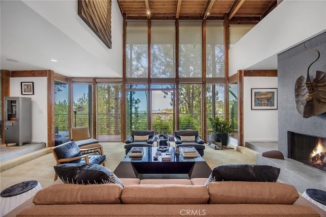 1503 Skylark Ln, Los Angeles, CA 90069 - carpeted living room with a warm lit fireplace, floor to ceiling windows, and a towering ceiling