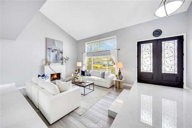 960 S Joliet Cir, Anaheim Hills, CA 92807 - living room with high vaulted ceiling, a premium fireplace, french doors, baseboards, and wood finished floors