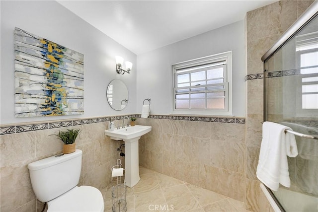 full bathroom featuring a healthy amount of sunlight, toilet, tiled shower, and vaulted ceiling