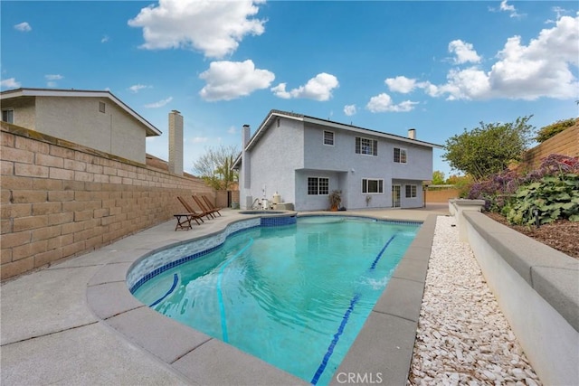 view of pool with a fenced in pool, a fenced backyard, and a patio area