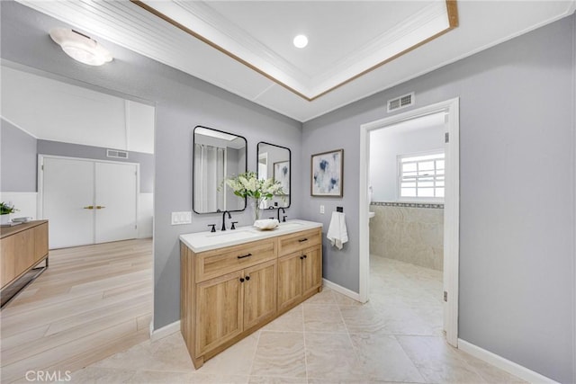 960 S Joliet Cir, Anaheim Hills, CA 92807 - full bath featuring double vanity, ornamental molding, baseboards, a raised ceiling, and tiled shower