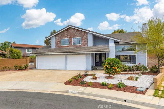 view of front of property featuring concrete driveway, stucco siding, fence, brick siding, and a garage