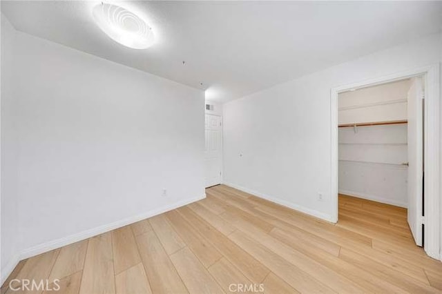 960 S Joliet Cir, Anaheim Hills, CA 92807 - unfurnished bedroom featuring light wood-type flooring, a spacious closet, a closet, and baseboards