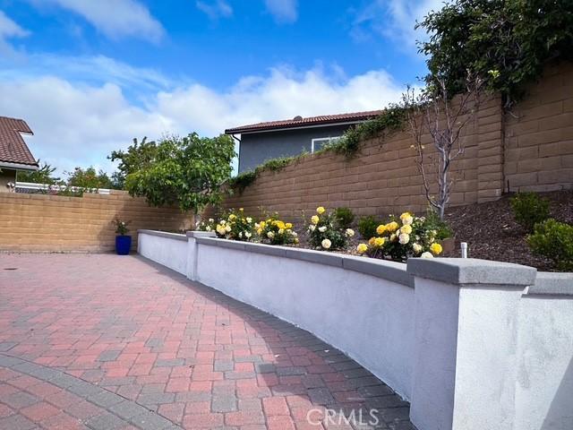 960 S Joliet Cir, Anaheim Hills, CA 92807 - view of side of property with a fenced backyard, stucco siding, and a patio