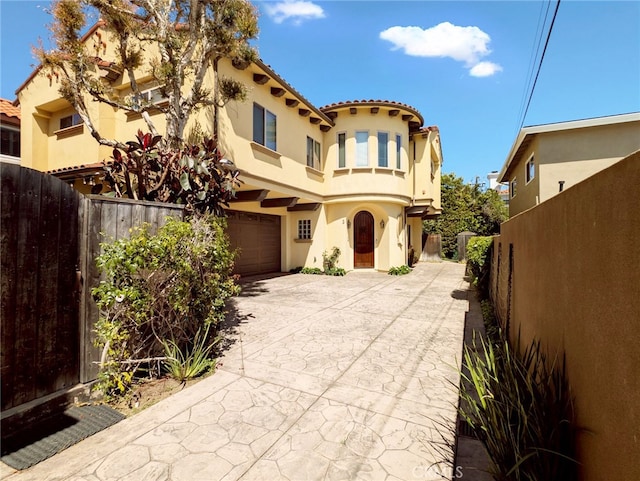 1907 Ernest Ave Unit B, Redondo Beach, CA 90278 - mediterranean / spanish house with stucco siding, an attached garage, concrete driveway, and a tile roof