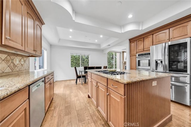 1907 Ernest Ave Unit B, Redondo Beach, CA 90278 - kitchen with stainless steel appliances, decorative backsplash, light wood-type flooring, a raised ceiling, and light stone countertops