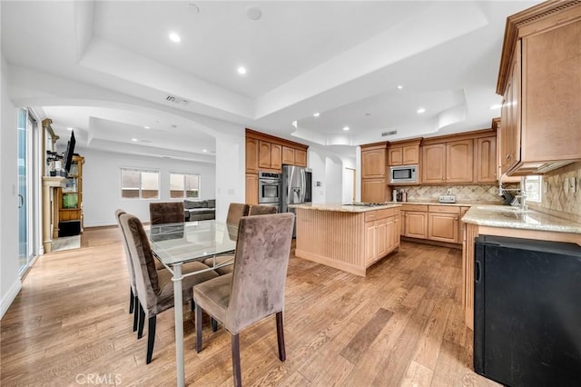 1907 Ernest Ave Unit B, Redondo Beach, CA 90278 - dining space featuring a raised ceiling, recessed lighting, light wood finished floors, arched walkways, and baseboards